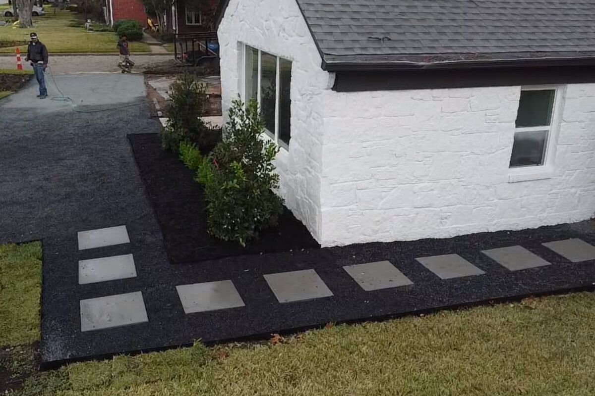 Clean paver walkway and fresh mulch beds at a North Texas home